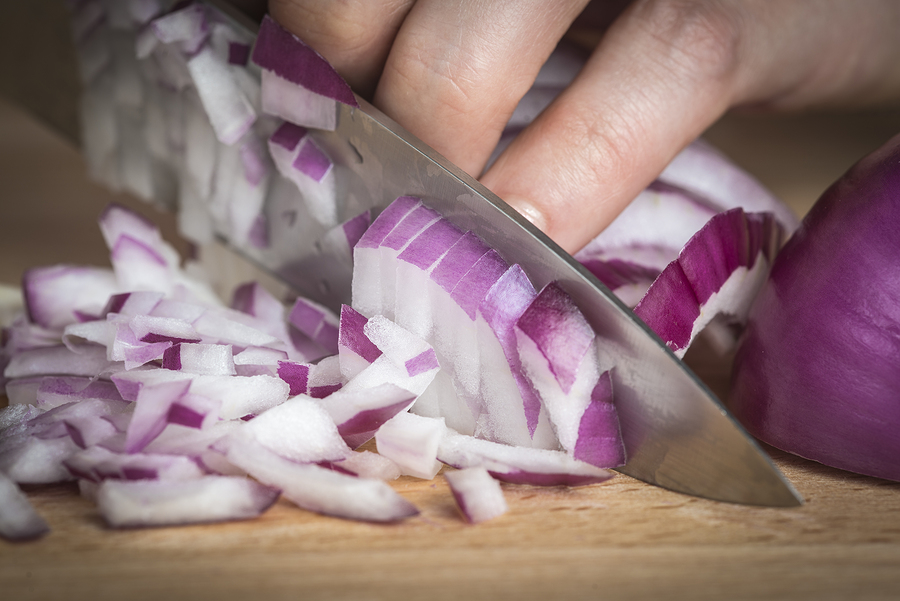 Chef Choppig A Red Onion With A Knife
