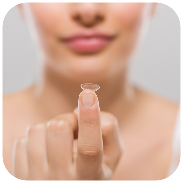 woman holding contact lens