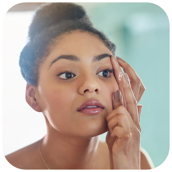 Woman putting on contact lens