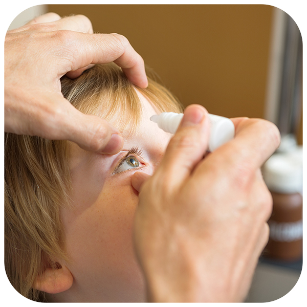 Woman using an eye drop