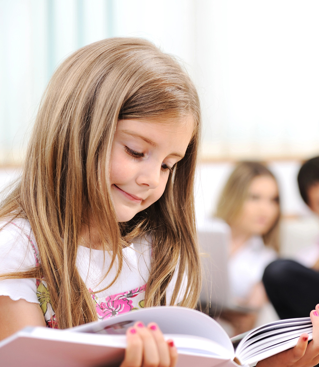 a girl reading a book in the classroom