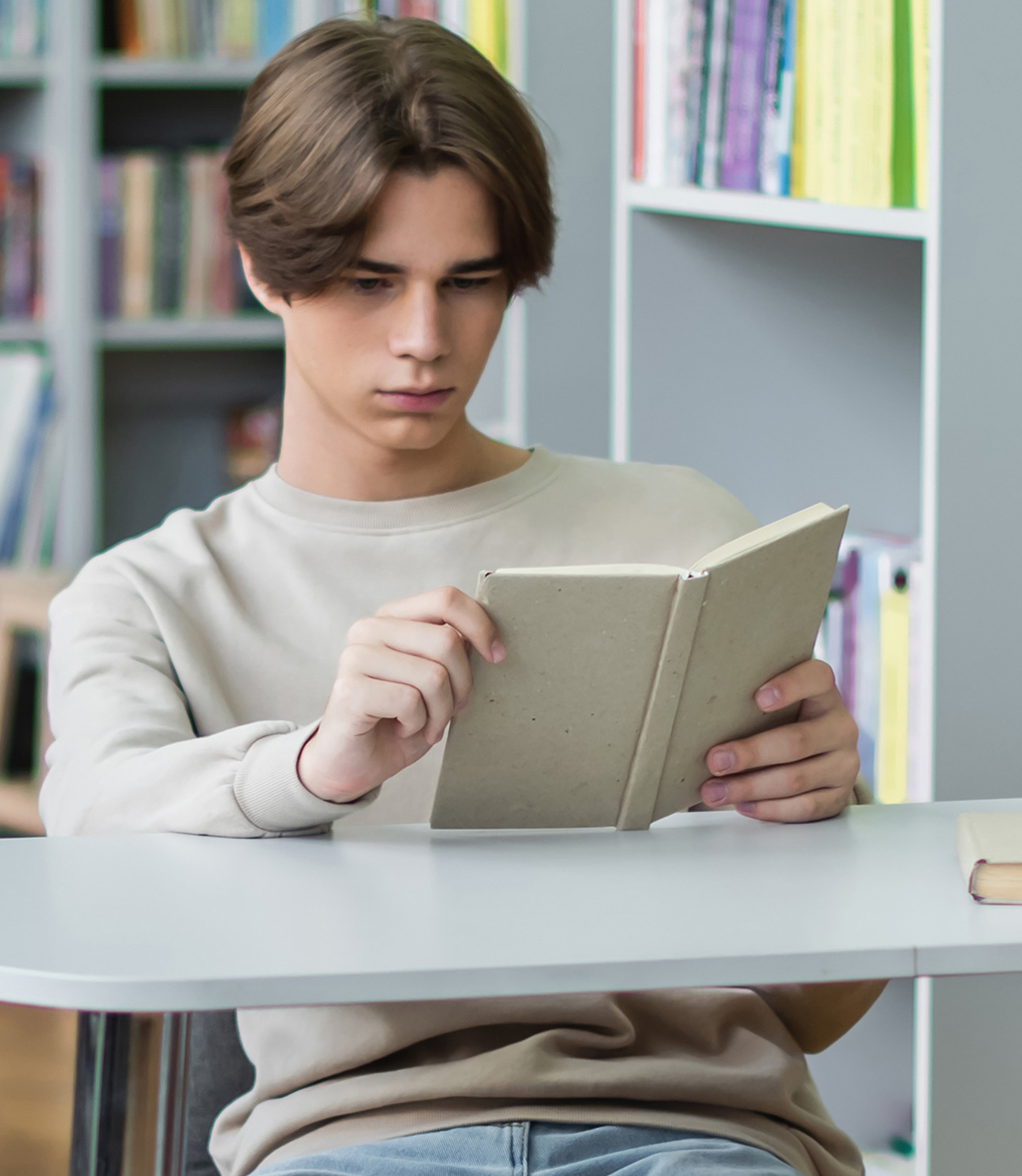 a girl reading a book in the classroom